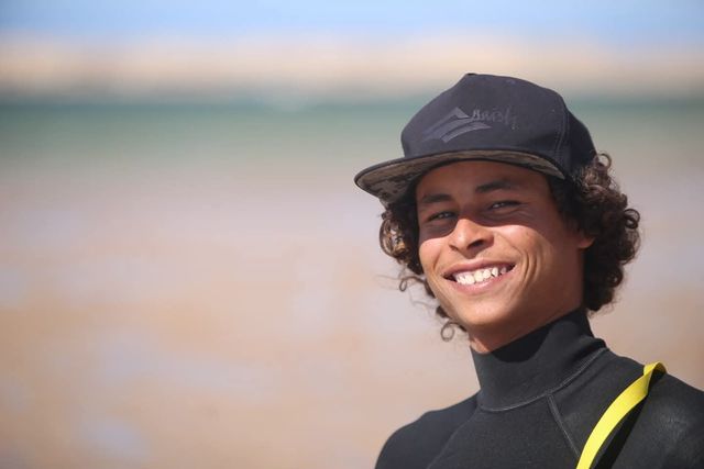 Abdo, kitesurfing and wingfoiling instructor, smiling at the lagoon